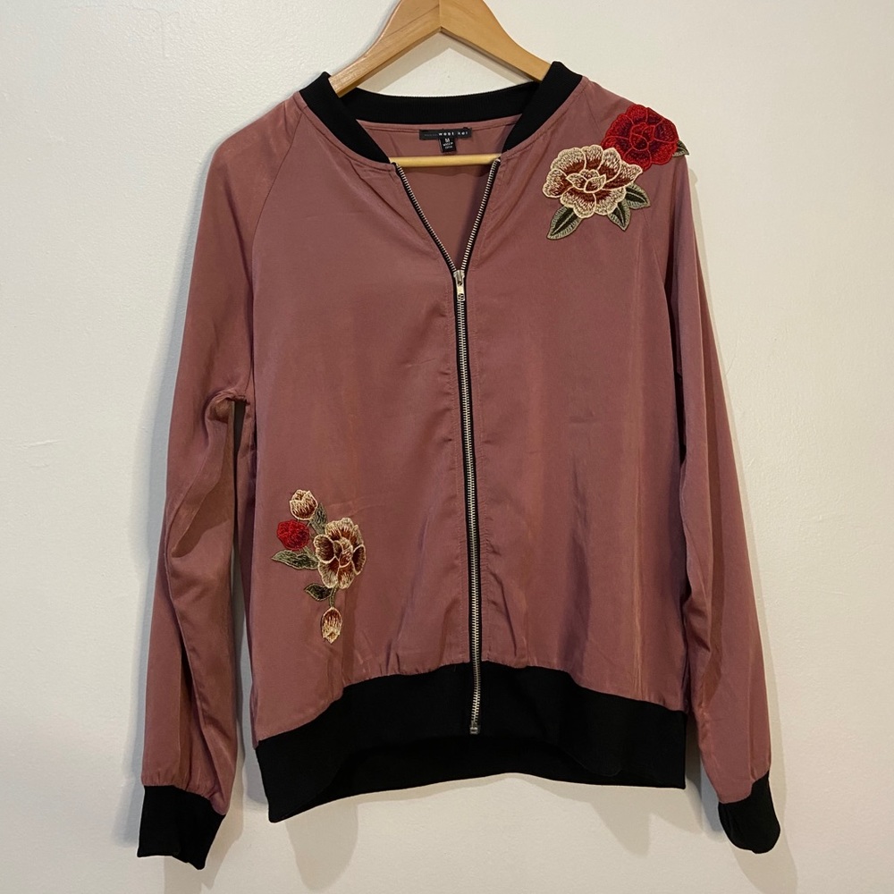 Pink varsity style jacket with embroidered flowers